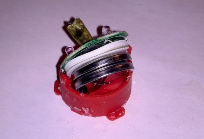 Color changing candle inside electronics with batteries exposed